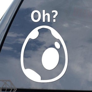 May include: White vinyl sticker with a white egg and the text "Oh?" on a black car window.