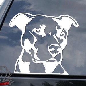 May include: White silhouette of a pit bull dog's head on a black car window.