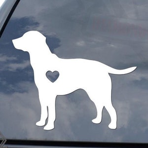 May include: White vinyl decal of a dog silhouette with a heart-shaped detail on the chest. The decal is applied to a car window, showcasing a simple yet endearing design. The sticker is a pet-themed accessory.