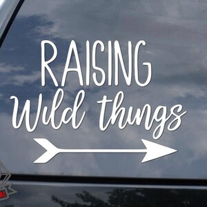 May include: White vinyl decal with an arrow pointing to the right and the text "Raising Wild Things".