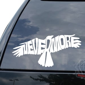 May include: White vinyl decal of a bird with the word "NEVERMORE" spelled out in the bird's body. The decal is on a car window.
