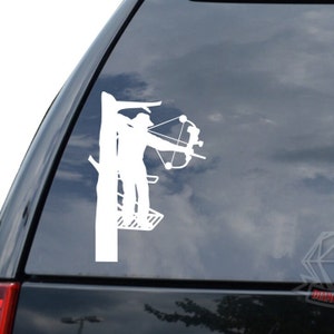 May include: White silhouette of a person holding a bow and arrow, standing on a platform in a tree. The silhouette is on a dark blue background.