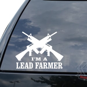 May include: White vinyl decal with two crossed rifles and the text "I'm a Lead Farmer".