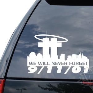 May include: White vinyl decal of the New York City skyline with the Twin Towers, a halo above them, and the text "We Will Never Forget 9/11/01".