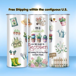 May include: White tumbler with a wraparound design featuring gardening tools, cacti, and the text "I'M A plantaholic ON THE ROAD TO Recovery...just kidding, I'm on my way! Get More Plants." Includes a garden fence and a watering can.