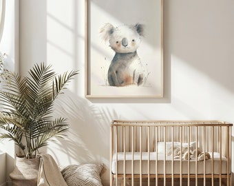 May include: A watercolor painting of a koala sitting in a field of grass. The koala is gray and white with a brown nose and black eyes. The painting is framed in a light wood frame and is hanging on a white wall.