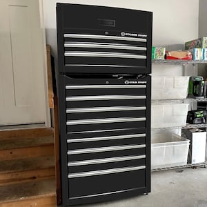 May include: A black Cold Stuff tool chest with multiple drawers and a top compartment. The drawers have silver handles. The tool chest is in a garage setting.