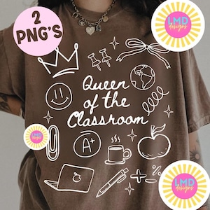 May include: A brown t-shirt with a white graphic design featuring the text "Queen of the Classroom" and various school-related icons such as a crown, apple, and pencil. The shirt also has two pink circles with the text "2 PNG's" and "LMD designs".