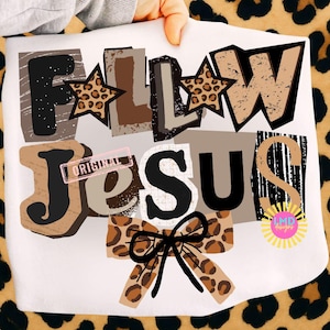 May include: White fabric featuring the words "FOLLOW JESUS" in a collage design. The letters use various colours and textures, including leopard print and distressed effects. A leopard print bow and stars accent the design.