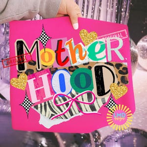 May include: A hot pink graphic design featuring the word "Motherhood" in a collage style with various patterns and colors. Includes gold glitter hearts, a bow, and the word "Original" stamped on the design.