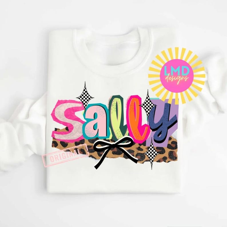 May include: White sweatshirt with the name "Sally" in colorful, layered text. The design includes a leopard print, a black bow, and starburst accents. The text "ORIGINAL" is stamped on the bottom left.