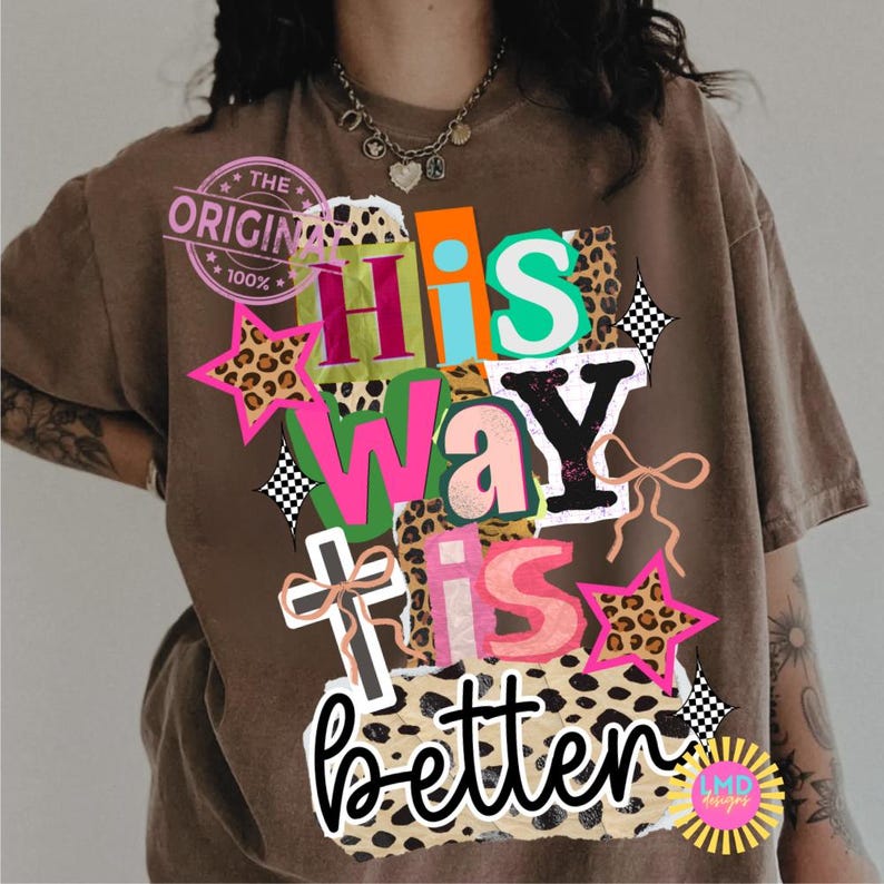 May include: Brown t-shirt with the text "His Way Is Better" in a colorful, patchwork design. The design includes stars, a cross, and leopard print accents. The shirt also has a "The Original" stamp.