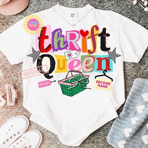 May include: White t-shirt with the words "Thrift Queen" in colorful, blocky letters. The design includes a shopping basket, stars, and the words "Original" and "Second Hand".