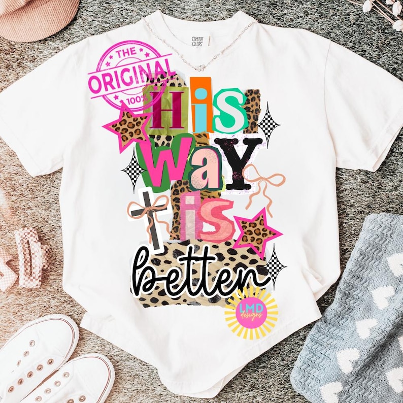 May include: White t-shirt with a colorful graphic that reads "His Way Is Better." The design includes leopard print, stars, and a cross. A pink stamp says "The Original 100%."