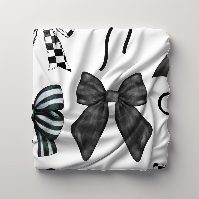 May include: A white fabric background with black and white checkered ribbon, black and white striped ribbon, and a large black bow. The background is wrinkled and has a slight sheen.