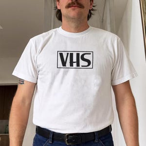 vhs shirt,
nostalgic shirt,
nostalgic tee,
90s shirt,
80s shirt,
movie fan gift,
movie fan shirt,
horror movie shirt,
vintage shirt,
cinephile hoodie,
y2k shirt,
retro movie shirt,
Retro Video Betamax