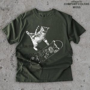 skateboarding cat shirt, retro cat graphic tee, vintage kitten tshirt, punk streetwear top, funny cat skate tee, oversized unisex shirt, cool beer cat tshirt, y2k skater aesthetic, 90s retro cat shirt, grunge coquette tee, rockstar gf cat top, mori kei skate shirt, streetwear cat graphic