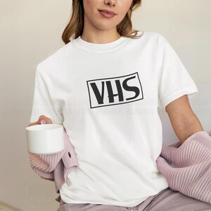 vhs shirt,
nostalgic shirt,
nostalgic tee,
90s shirt,
80s shirt,
movie fan gift,
movie fan shirt,
horror movie shirt,
vintage shirt,
cinephile hoodie,
y2k shirt,
retro movie shirt,
Retro Video Betamax