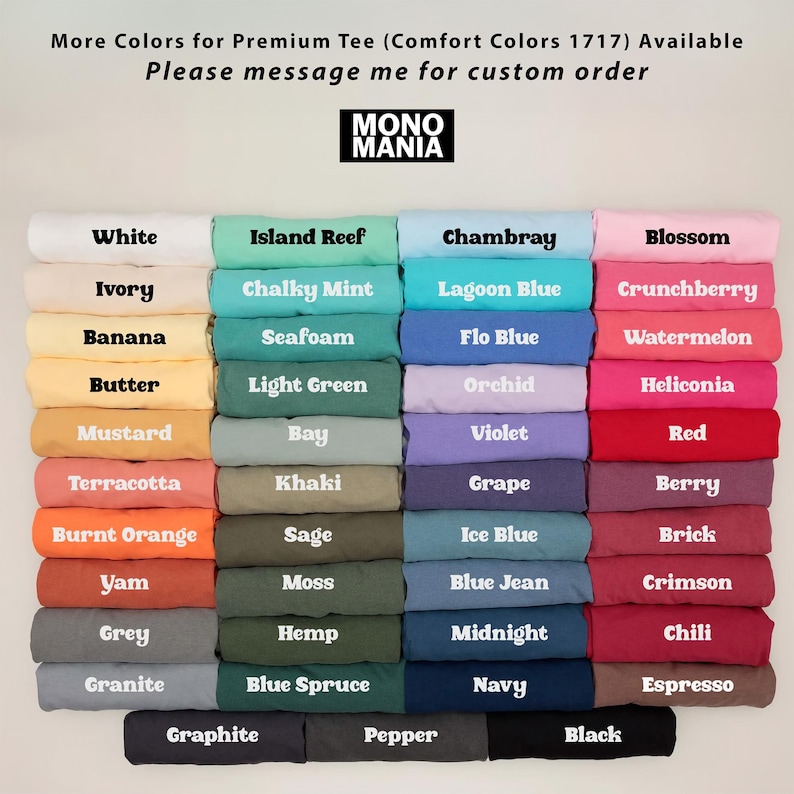 May include: A display of folded t-shirts in various colors, including white, blue, green, and pink. Each shirt is labeled with its color name, such as "White," "Island Reef," and "Chambray." The brand logo "MONO MANIA" is visible.