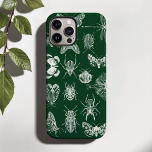 May include: A set of three ceramic mugs with a speckled, matte finish. The mugs are in shades of cream, light gray, and dark gray. Each mug has a simple, minimalist design and a rounded handle.