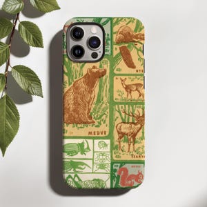 May include: A phone case featuring a vintage-style stamp collage design in shades of green, tan, and brown. The print displays various wildlife illustrations including a bear, deer, elk, squirrel, and several insects, with text labels like MEDVE.