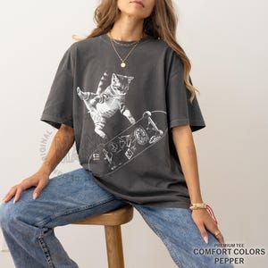 skateboarding cat shirt, retro cat graphic tee, vintage kitten tshirt, punk streetwear top, funny cat skate tee, oversized unisex shirt, cool beer cat tshirt, y2k skater aesthetic, 90s retro cat shirt, grunge coquette tee, rockstar gf cat top, mori kei skate shirt, streetwear cat graphic