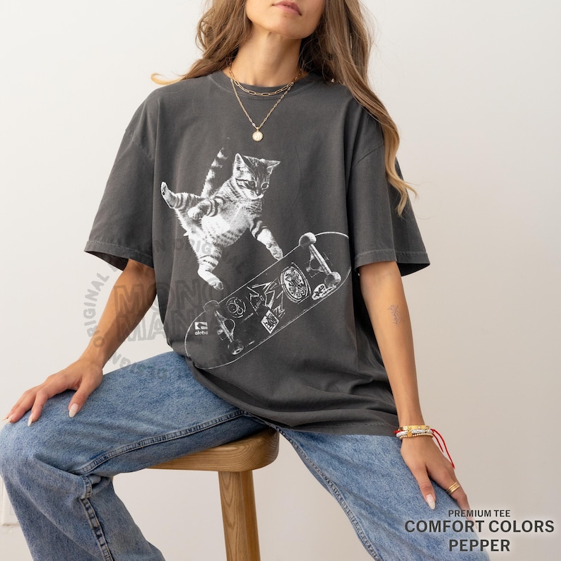 skateboarding cat shirt, retro cat graphic tee, vintage kitten tshirt, punk streetwear top, funny cat skate tee, oversized unisex shirt, cool beer cat tshirt, y2k skater aesthetic, 90s retro cat shirt, grunge coquette tee, rockstar gf cat top, mori kei skate shirt, streetwear cat graphic