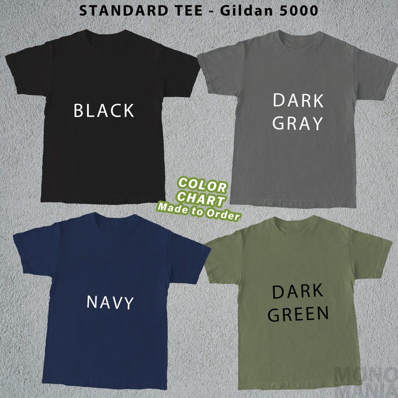 May include: A color chart featuring four Gildan 5000 standard tees in black, dark gray, navy, and dark green. Each shirt displays its color name in white text. The chart also includes the text "Color Chart Made to Order."