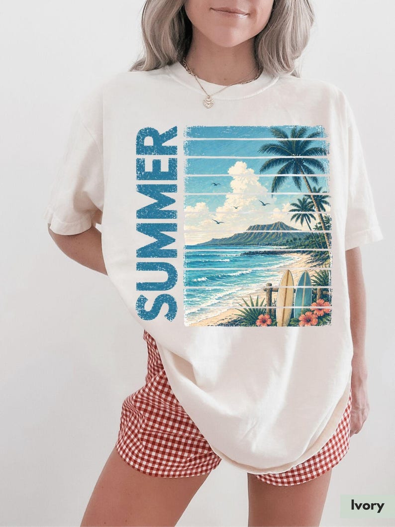 May include: Ivory-colored t-shirt featuring a tropical beach scene with the word "SUMMER" in blue vertical text. The graphic includes palm trees, surfboards, and ocean waves. The shirt is paired with red and white checkered shorts.