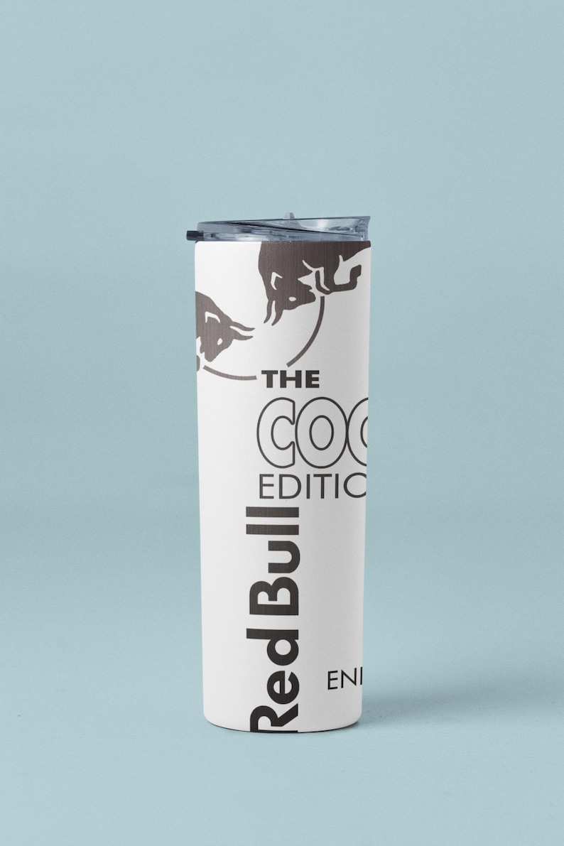 May include: White insulated tumbler with a black lid. The tumbler features the Red Bull logo and the text "THE COCO EDITION". The design includes a bull graphic.