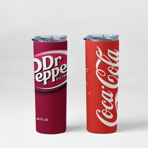 May include: Two insulated tumblers, one with a Dr Pepper logo and the other with a Coca-Cola logo. The Dr Pepper tumbler is burgundy with white text and reads "20 FL OZ". The Coca-Cola tumbler is red with white text and has water droplets.