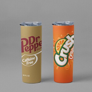 May include: Two 20 fl oz insulated tumblers. One features the Dr Pepper logo in maroon on a tan background, with "Caffeine Free" and "Est. 18" text. The other is orange with the Crush logo and an orange slice graphic.