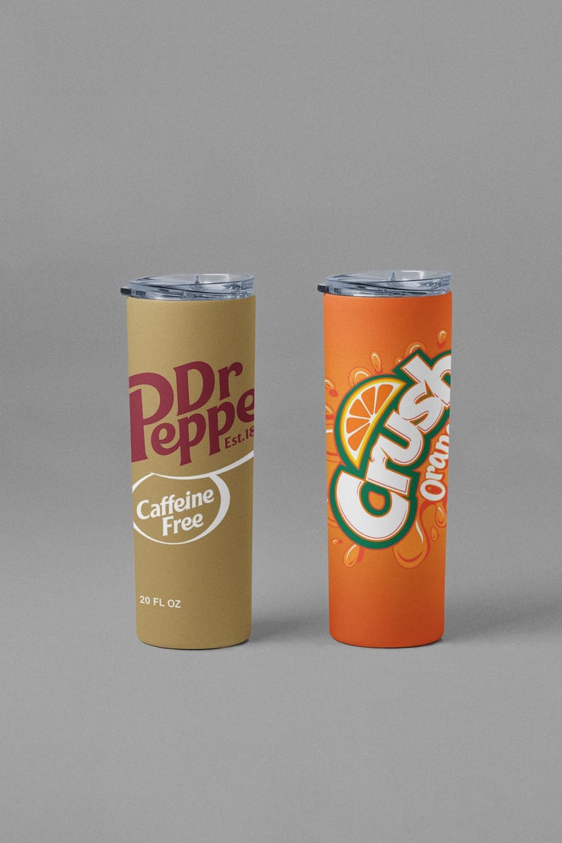 May include: Two 20 fl oz insulated tumblers. One features the Dr Pepper logo in maroon on a tan background, with "Caffeine Free" and "Est. 18" text. The other is orange with the Crush logo and an orange slice graphic.