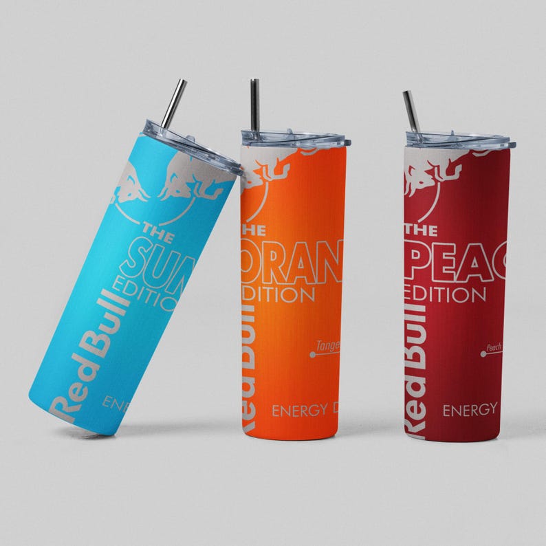 May include: Three Red Bull stainless steel tumblers with straws. The tumblers are in blue, orange, and red, each with a different edition name: "Sun", "Oran", and "Pea". The Red Bull logo is visible on each tumbler.