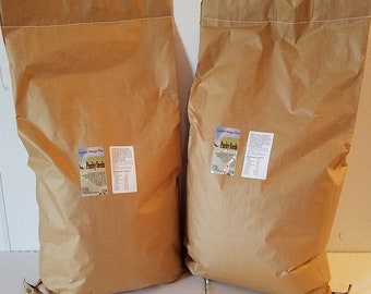 May include: Two large brown paper bags filled with Purity Seeds Golden Omega Flax. The bags have a white label with the company logo and product information.