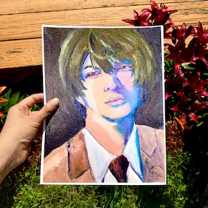 May include: An oil painting of a person with olive green hair, wearing a brown suit jacket, white shirt, and a dark brown tie. The painting has a dark background and is held by a hand. The painting is signed "K.Lee."