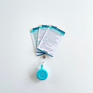 May include: Three blue and white reference cards with a retractable badge holder. The cards have the title "REFERENCES" and "CHANGING TO EQUIANALGESIC DOSES OF OPIODS".