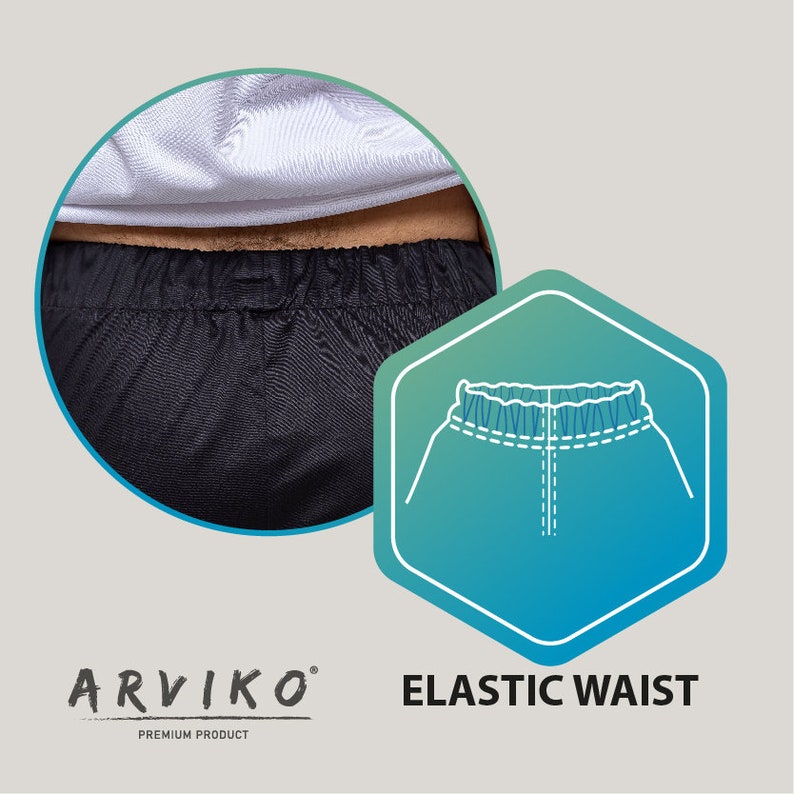 May include: Close-up of the black elastic waistband of a pair of pants. The waistband is made of a soft, stretchy material and has a drawstring for a comfortable fit. The text "ELASTIC WAIST" is visible in the image.