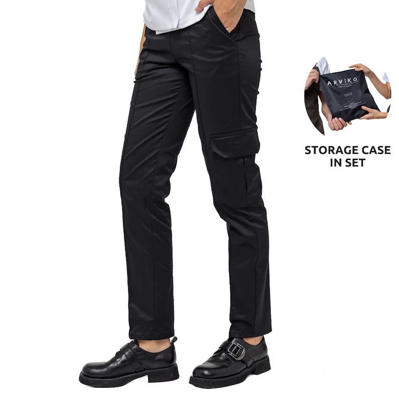May include: Black cargo pants with a large pocket on the right leg. The pants are worn by a person with black shoes. The image also shows a black storage case with the text "ARVIKO" printed on it. The text "STORAGE CASE IN SET" is also included in the image.