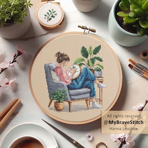 May include: Cross-stitch art featuring a woman in a chair, stitching a floral design. The scene includes potted plants, embroidery hoops, and craft supplies. The artwork is set against a neutral background with the text "All rights reserved @MyBraveStitch Hanna Levchuk."