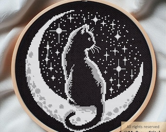 May include: Cross-stitch embroidery in a wooden hoop. The design features a black cat sitting on a crescent moon against a starry night sky. The text "All rights reserved @MyBraveStitch Hanna Levchuk" is visible.
