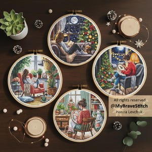 May include: Four circular wooden embroidery hoops featuring cross-stitch designs of cozy indoor scenes with people reading or crafting near Christmas trees and windows. Text on the image reads: All rights reserved @MyBraveStitch Hanna Levchuk.