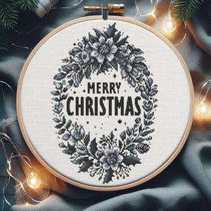 May include: Black and white cross-stitch embroidery hoop with a floral wreath design and the text "Merry Christmas".
