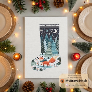 May include: A cross-stitch Christmas stocking design depicting a winter forest scene with a fox. The stocking is filled with evergreen trees, snowflakes, and a crescent moon. The word "CHRISTMAS" is stitched at the top. The design is on a white canvas.