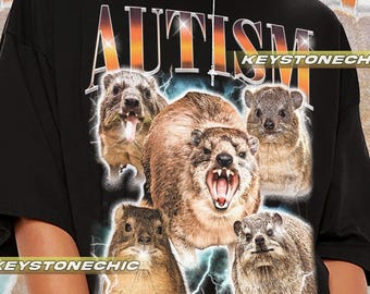 May include: Black t-shirt with a graphic print of five animals with the word "AUTISM" in large letters above them. The text "KEYSTONECHIC" appears twice on the shirt.