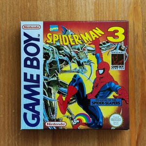 Könnte beinhalten: Eine Nintendo Game Boy Spielkassette für Spider-Man 3. Die Box zeigt Spider-Man in einem rot-blauen Anzug, mit einem grünen und silbernen Robotergegner. Die Box hat die Logos von Nintendo und Marvel Comics.
