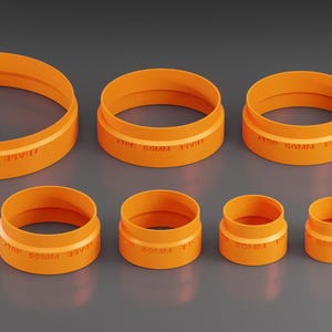 Op de afbeelding: Een set van acht oranje plastic ringen in verschillende maten. De ringen zijn gelabeld met hun diameter in millimeters.