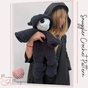 May include: A dark blue crochet doll resembling a grim reaper, featuring a white skull face and black hood. The doll is held by a person in a black hooded cloak. The image includes the text "Snuggler Crochet Pattern" on the right side.