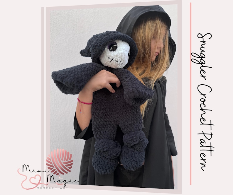 May include: A dark blue crochet doll in the shape of a grim reaper, with a white skull face and black hood. The doll is held by a person wearing a black hooded cloak. The text "Snuggler Crochet Pattern" is on the right side of the image.