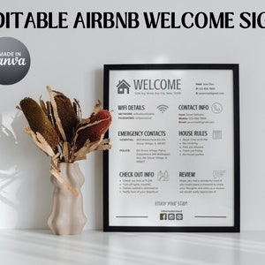 May include: An editable Airbnb welcome sign in a black frame. The sign includes welcome text, Wi-Fi details, contact information, house rules, check-out info, and a review section. The sign is next to a beige vase with dried flowers. The words "EDITABLE AIRBNB WELCOME SIGN" are at the top.